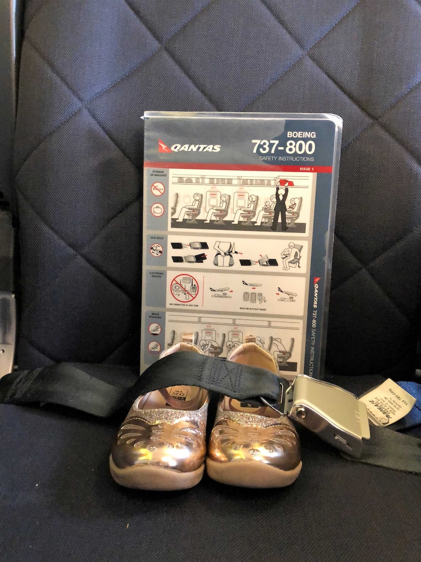 Shoes on an aeroplane seat