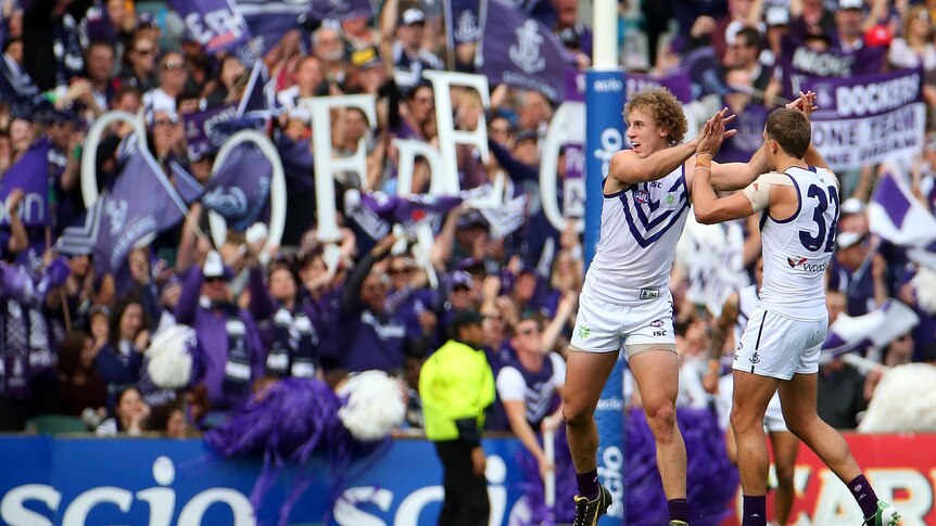 The Dockers' Chris Mayne and Stephen Hill celebrate a goal against the Eagles.