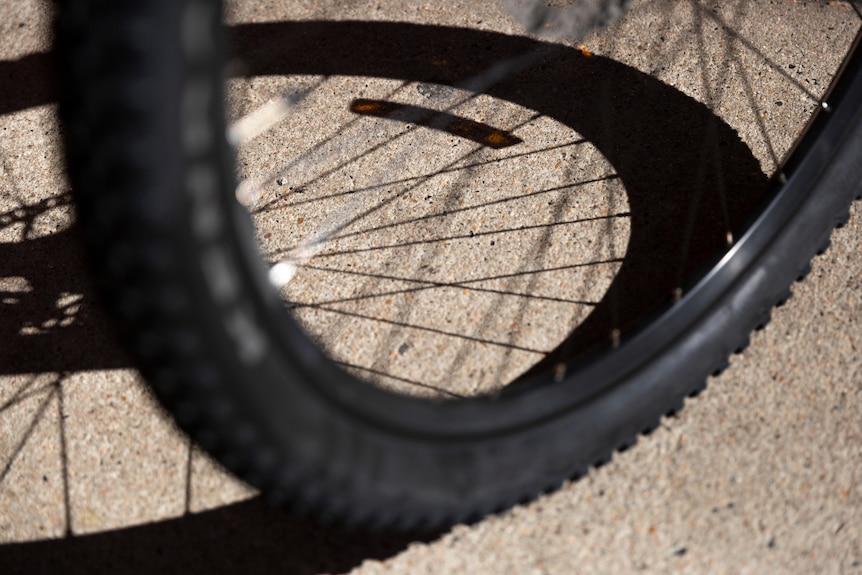 A close up image of a mountain bike tyre and wheel spokes