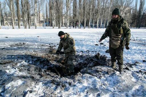 A Ukranian soldier inspects a crater left by the explosion in Avdiivka.