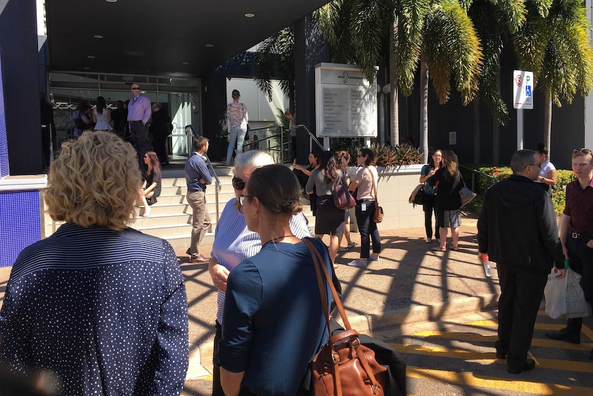 People stand outside a building.