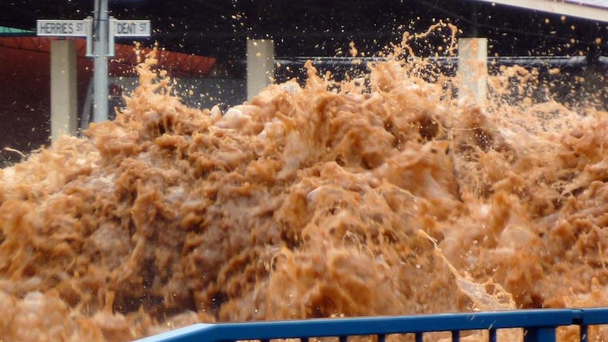 Flash floods surge down a street in Toowoomba