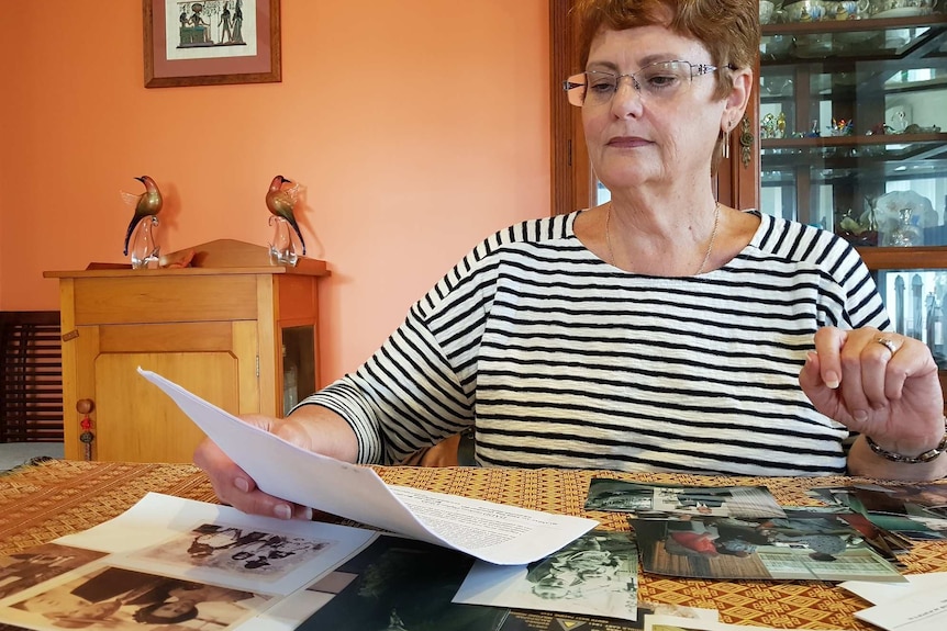 Sue Brown looks at family photos.