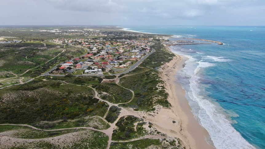 Scarp and the ocean surround a small coastal town
