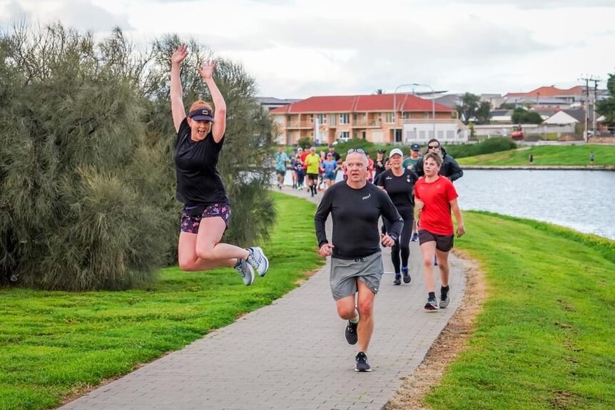 Kate Corner jumps in the air during parkrun.