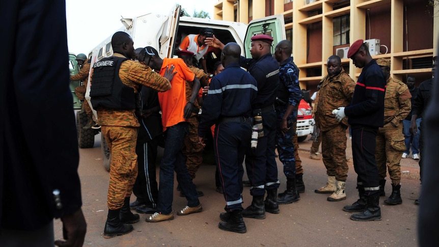 Men escorted into a van.