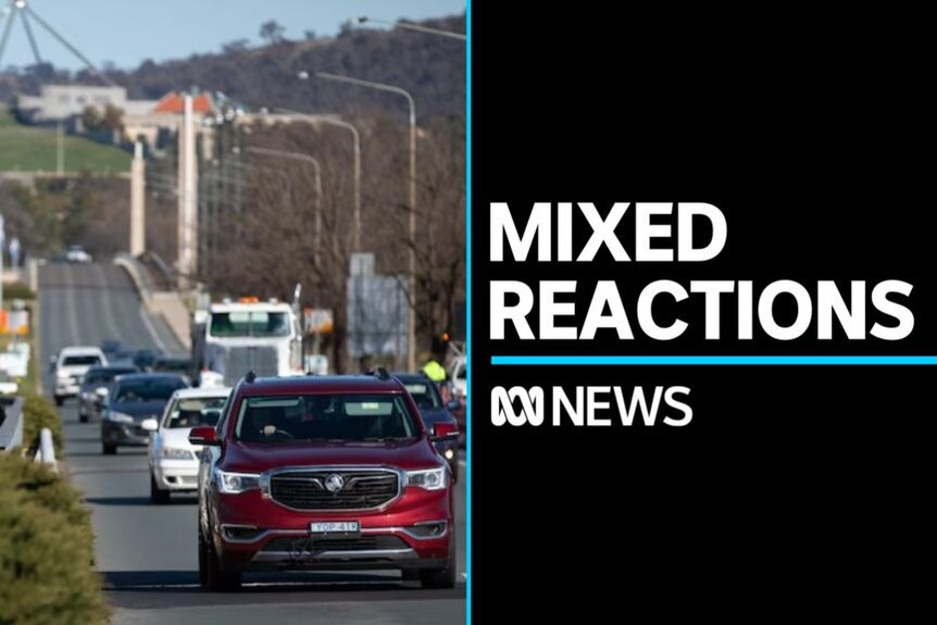 Mixed Reactions: Cars drive on a road with Parliament House in the background