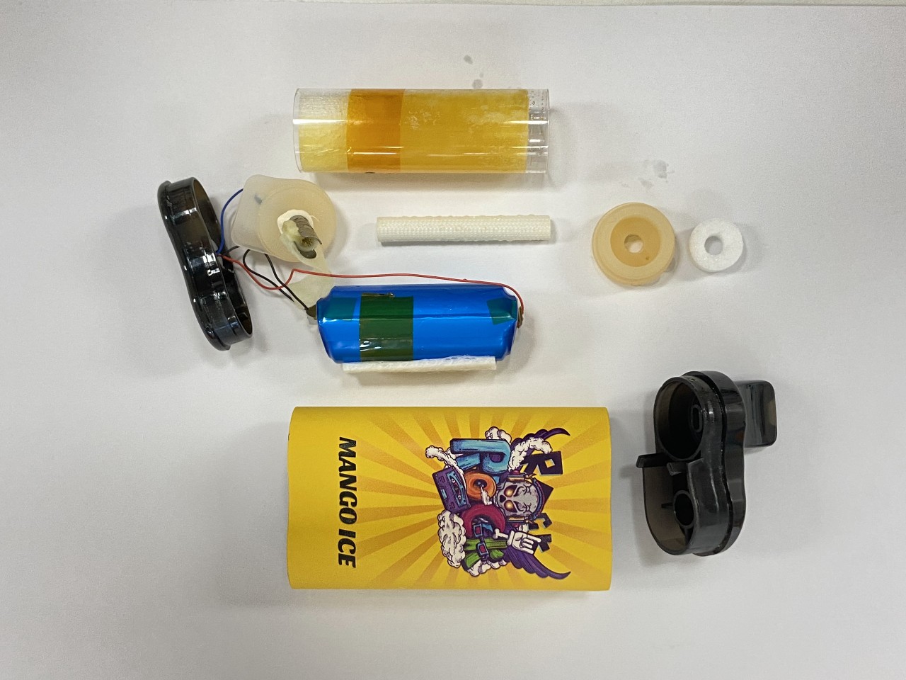 A standard vape taken apart showing battery, mouthpiece, cartridge