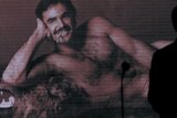 Arnold Schwarzenegger silhouetted in front of famous Burt Reynolds picture