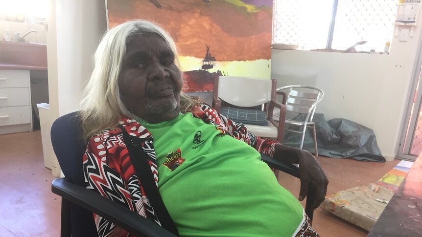 Artist Ivy Pareroultja sitting on a chair at the Iltja Ntjarra Many Hands Art Centre in Alice Springs.
