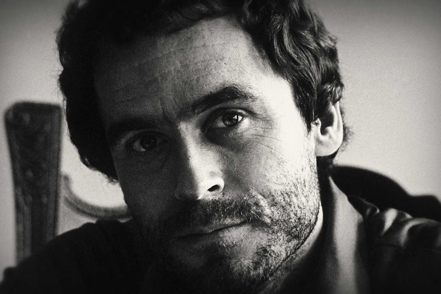 A black and white portrait of American serial killer Ted Bundy.