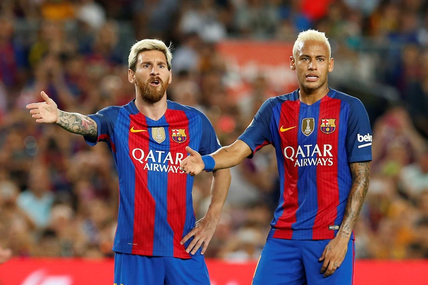 Barcelona's Lionel Messi and Neymar argue with the referee against Alaves