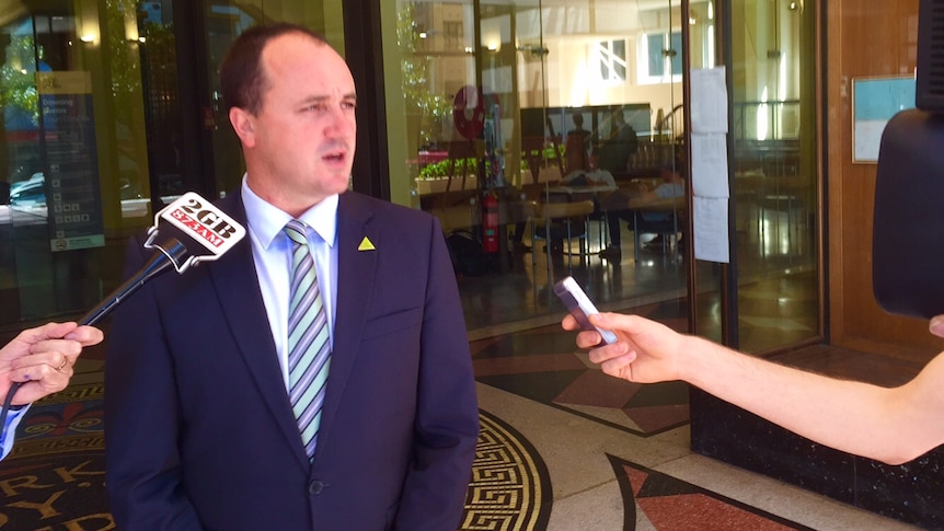 Jeremy Buckingham speaking to reporters outside of court.