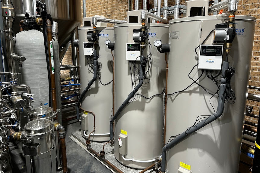 A row of hot water tanks at a brewery.