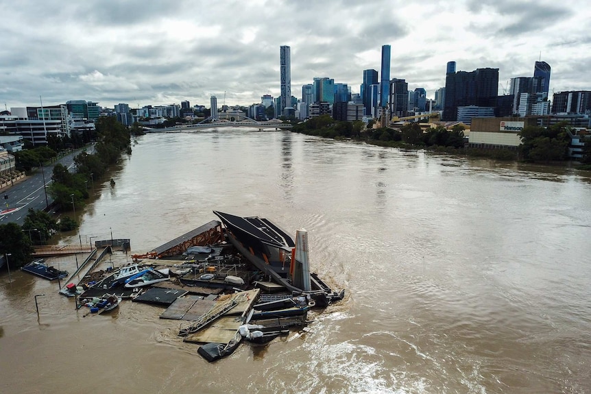 A ferry terminal surrounded by debris in the Brisbane River.