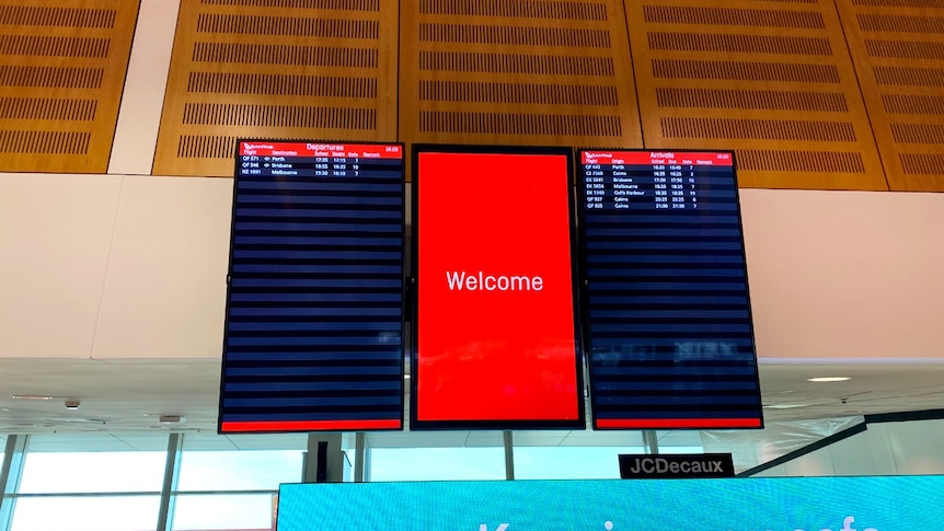A near-empty arrivals and departures sign at Sydney Airport, with three flights listed under 'departures'.