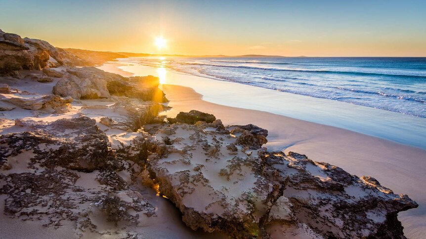 A sunrise over the beach and water at Sleaford Bay, in Lincoln National Park on the Eyre Pensinsula, SA.