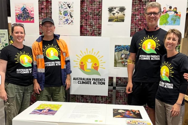 Two men and two women with matching t-shirts that read "Australian parents for climate action"