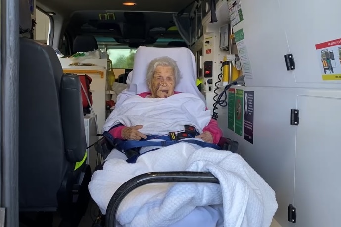 An elderly woman inside an ambulance