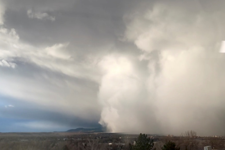 A large grey cloud sweeps across the landscape. 