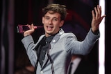 Flume holds his ARIA with his hands in the air