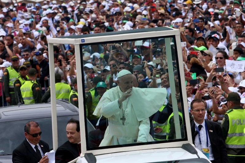 From his popemobile, Francis waves to heavy crowd