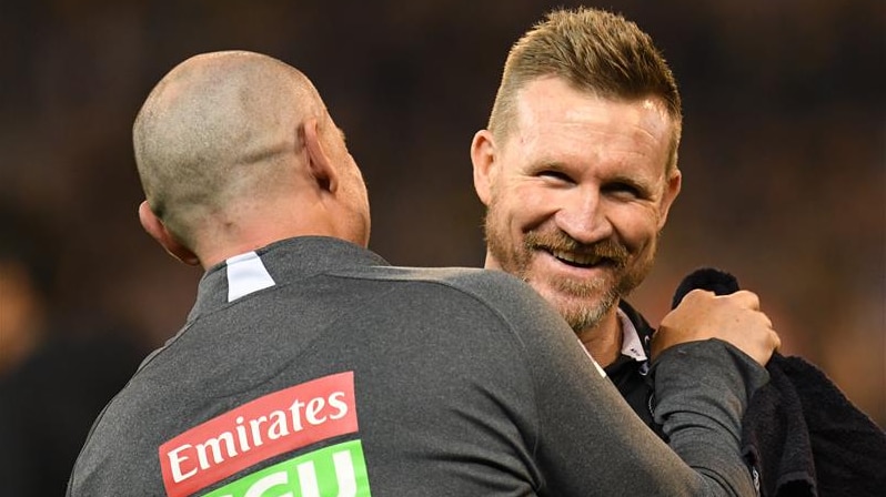 Coach Nathan Buckley (R) reacts after Collingwood's 2018 preliminary final win over Richmond.