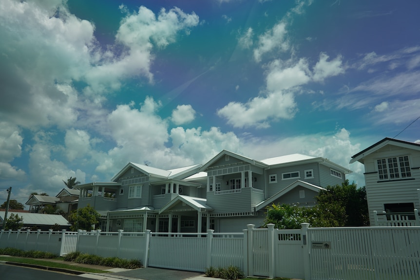 A sunny street with big houses. 