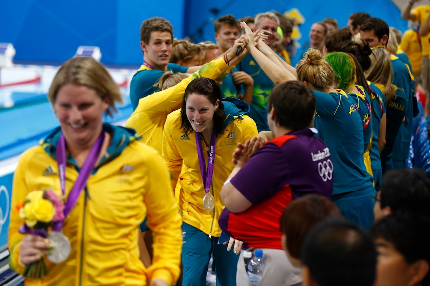 Australia's Olympic team members celebrate with women's relay team after the claimed silver.