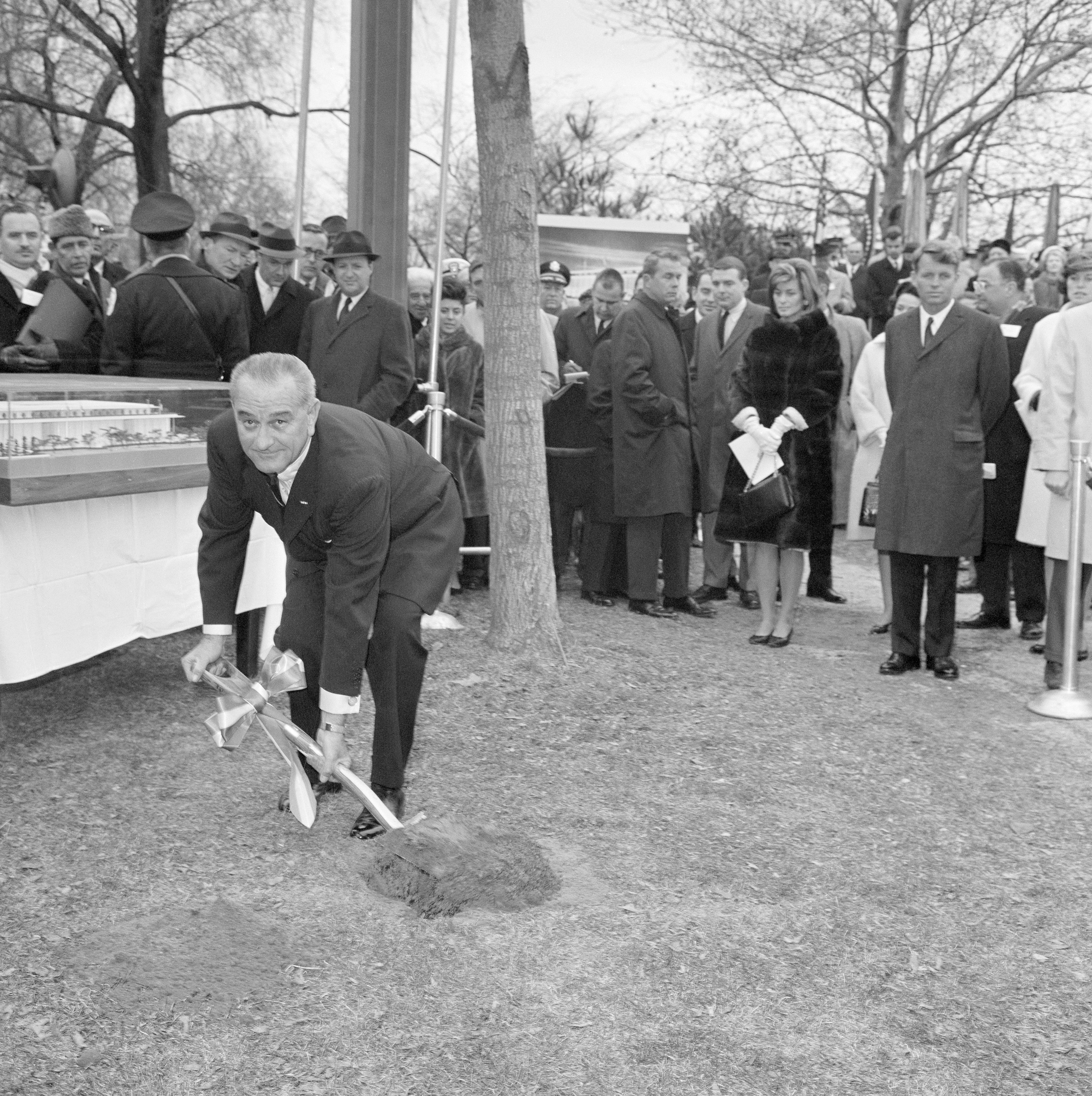 A man digging a hole with a shovel.