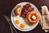 Traditional full american breakfast eggs pancakes with bacon and toast 