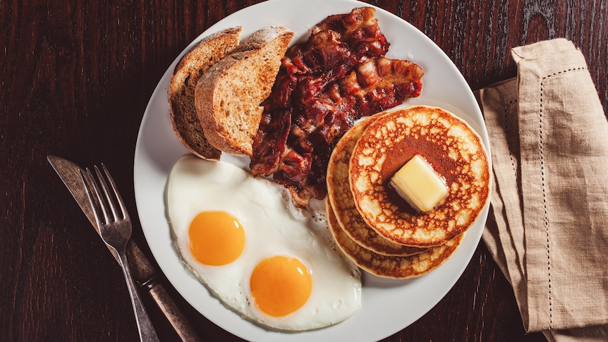 Traditional full american breakfast eggs pancakes with bacon and toast 