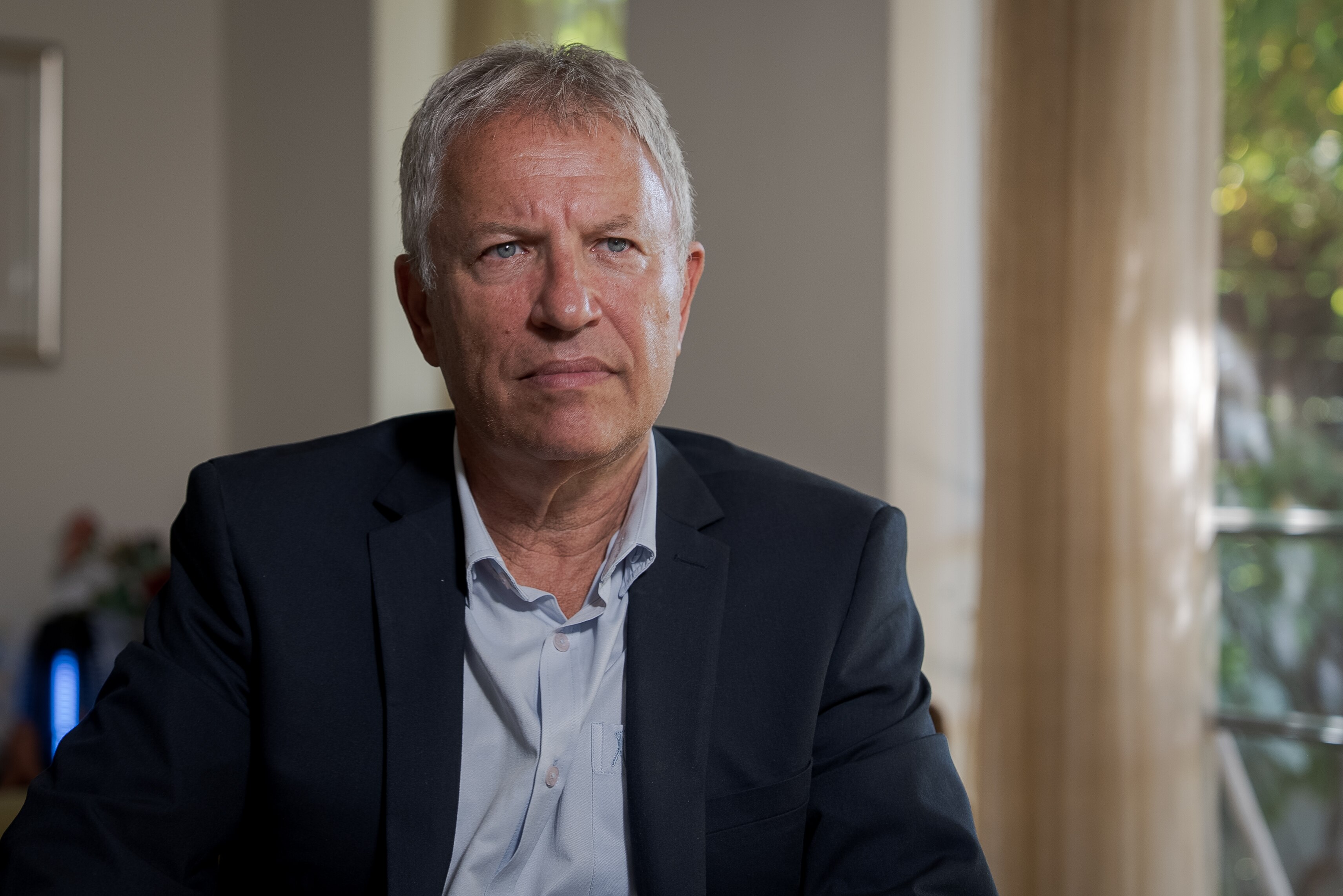 A serious-looking grey-haired man.