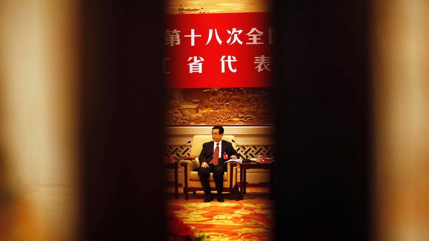 A delegate waits for a meeting in the Great Hall of the People in Beijing