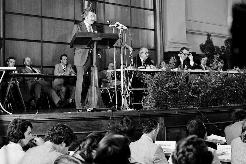 Bob Hawke stands at a lectern addressing the Biennial Congress of Trade Unions in 1975.