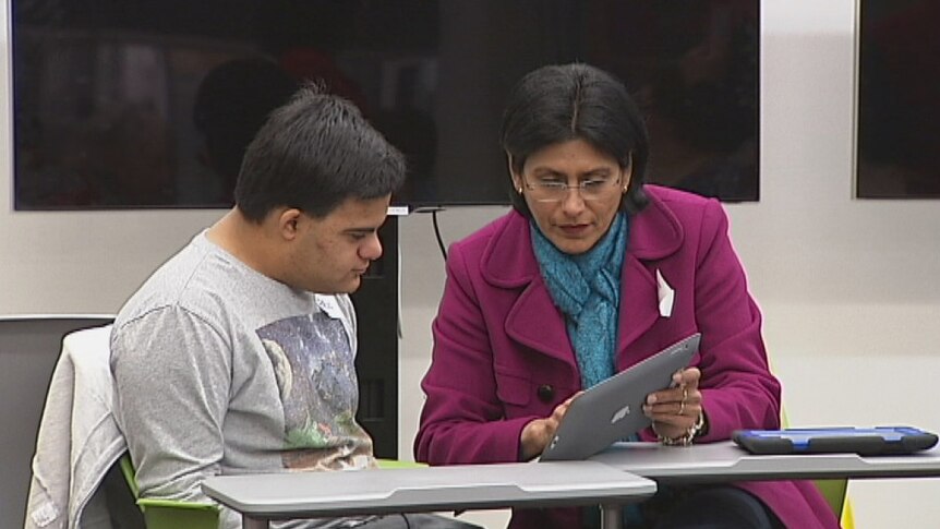 Mother and son Ami and Paul Iacuone learn how to use iPads during a program at the Digital Hub at the Gungahlin Library.