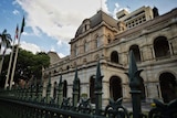 Queensland Parliament House in Brisbane looking through front fence with the top of the Executive Annexe in the background.