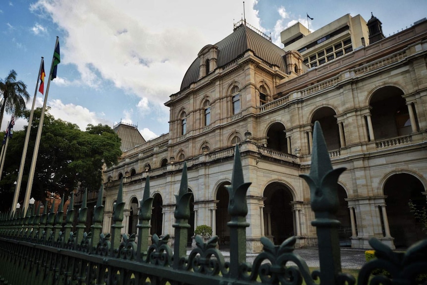 Queensland Parliament House in Brisbane looking through front fence with the top of the Executive Annexe in the background.