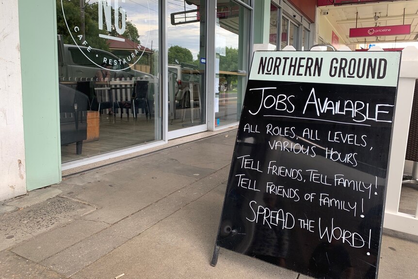 A frame chalkboard advertising for workers.