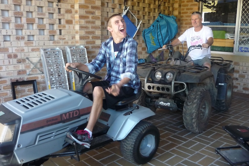 Two men sitting on quad bikes