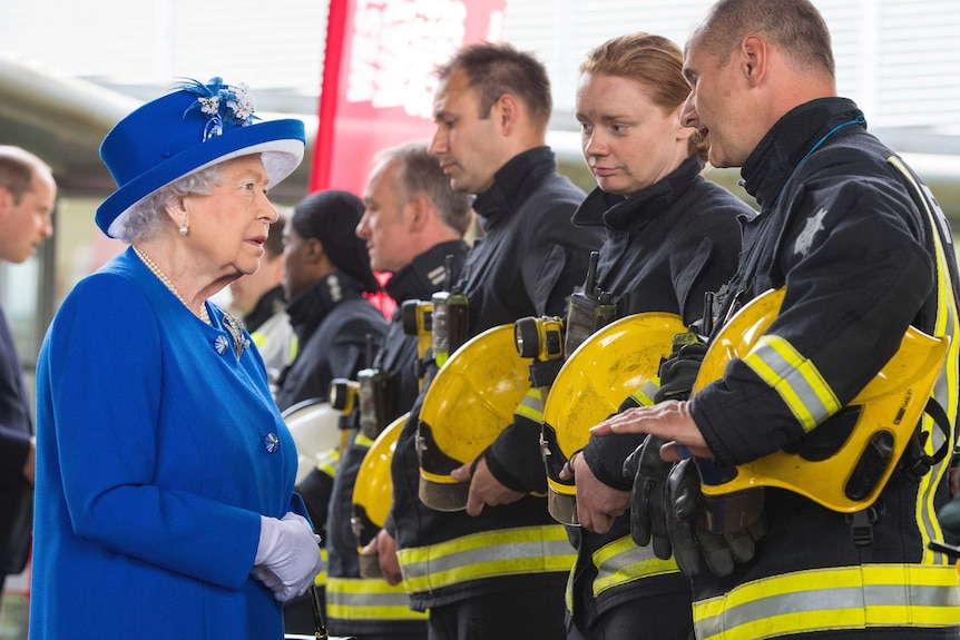 Britain's Queen Elizabeth II meets emergency services personnel during a visit to the Westway sports centre.