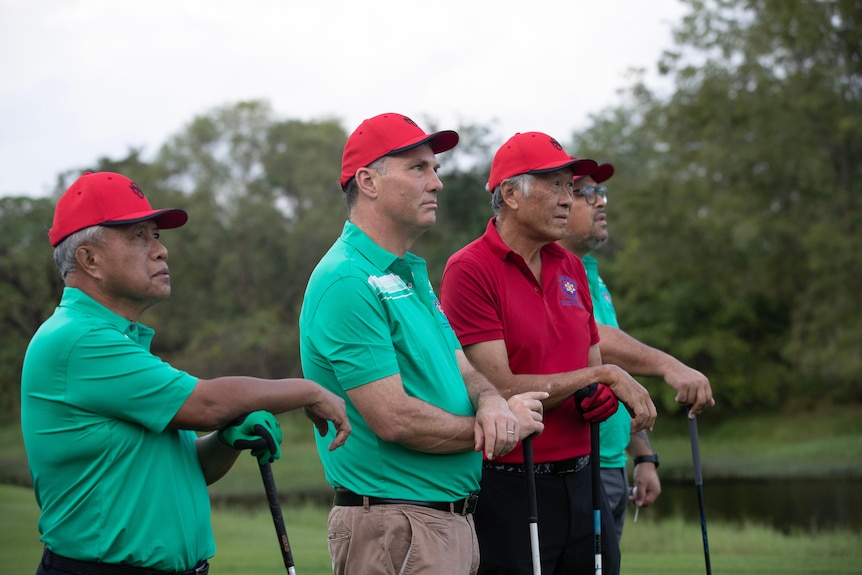 Richard Marles stands on a golf course alongsise his south east asian counterparts
