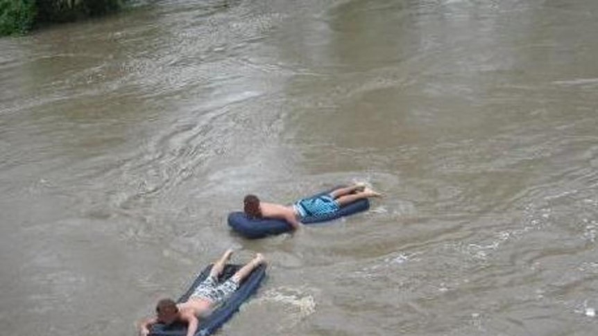 The three boys were attempting to ride down the swollen Bremer River into Brisbane's CBD
