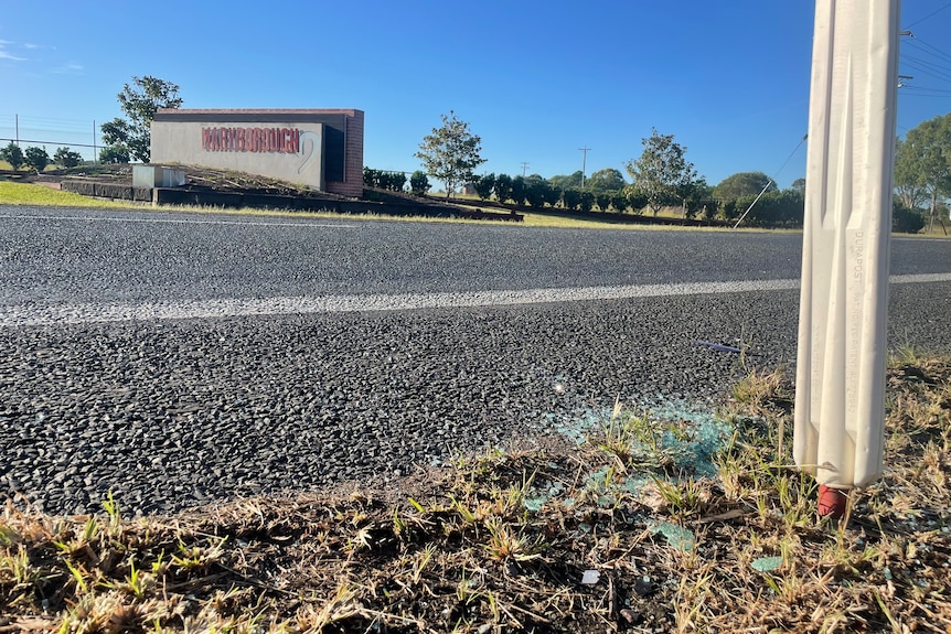 Glass on ground with Maryborough town sign in background