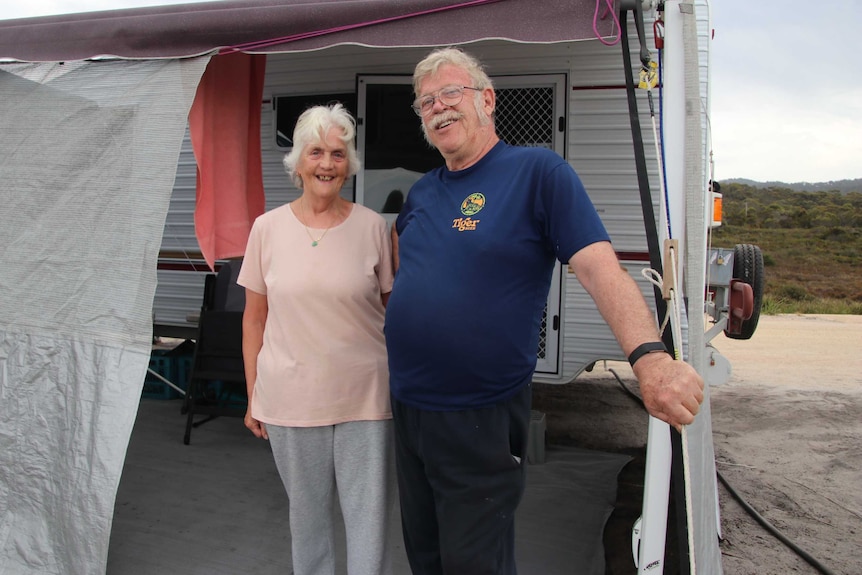 Marg Box and Allan Fradley standing outside their caravan at Swimcart Beach on the east coast