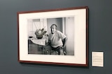 A black and white photograph of Donald Friend hanging on the wall of the Tweed Regional Gallery.