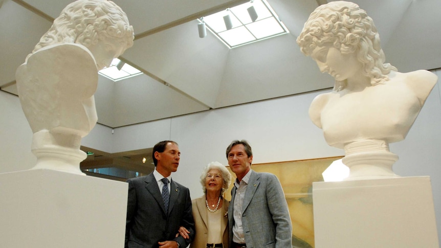 Guido, Amina and Luca Belgiorno-Nettis look at two sculptures at the Art Gallery of NSW.