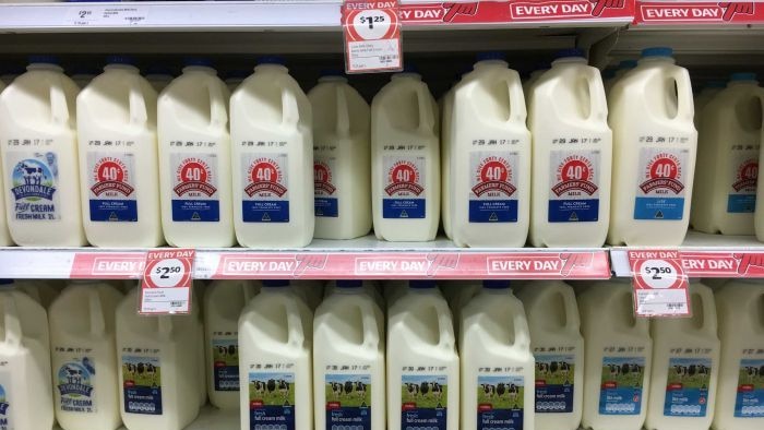 Picture of milk priced at one dollar per litre on supermarket shelves.