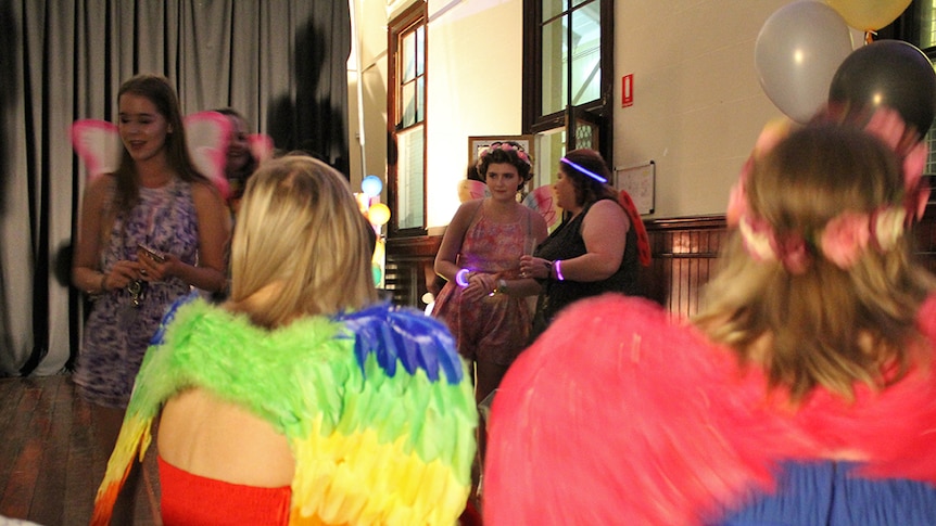 Wide shot of people wearing colourful outfits at the Rainbow Formal in Townsville