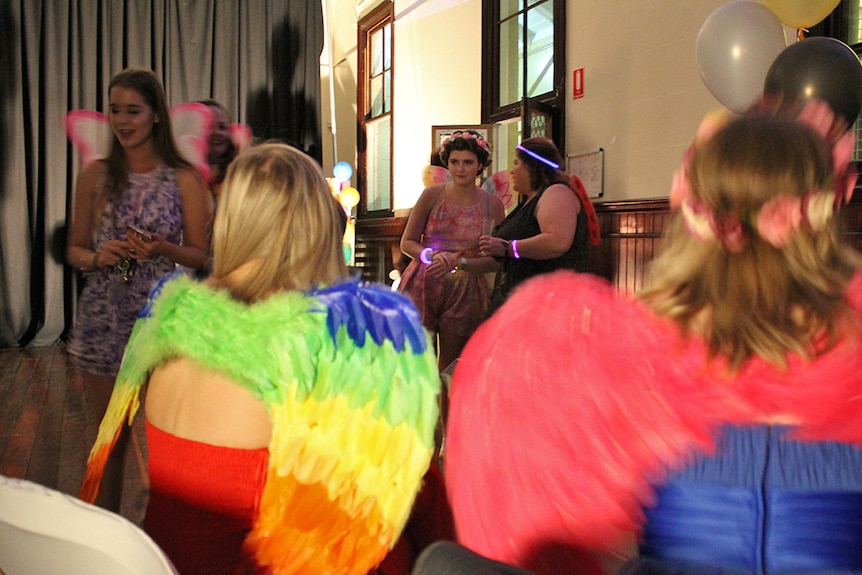 Wide shot of people wearing colourful outfits at the Rainbow Formal in Townsville
